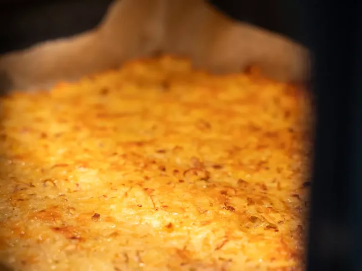 Crousti-galette de pommes de terre étalée sur une plaque de cuisson dans le four